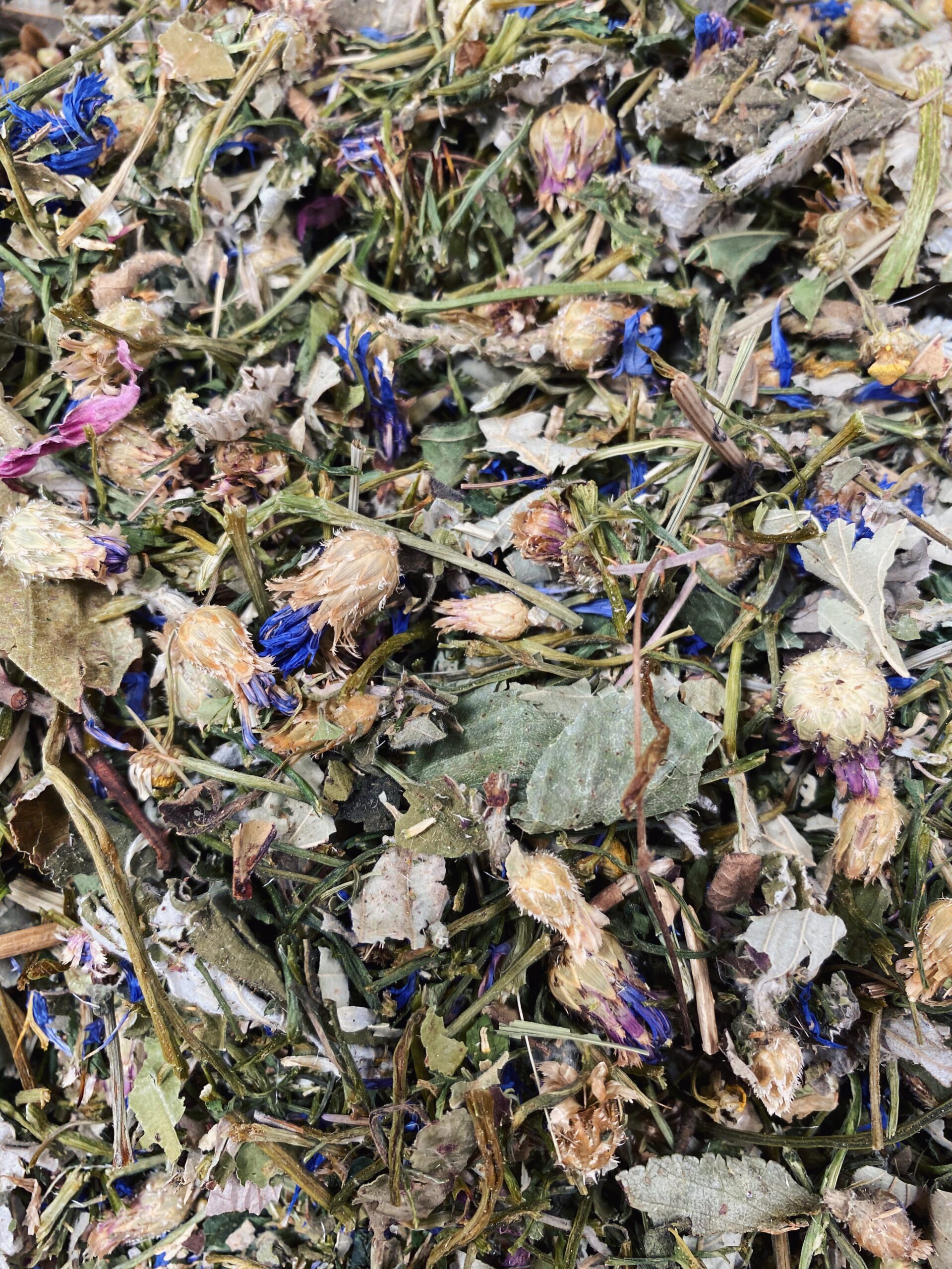 Assortment of dried herbs including parsley, cornflowers, and chamomile in the Herb Garden blend from Pillow Wad's Nibbley Bits range.